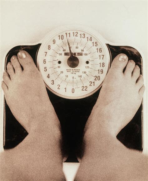 Womans Feet On A Set Of Weighing Scales Photograph By Cristina