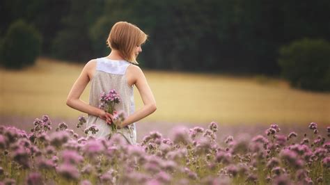 girl with flowers standing in field wallpaper hd girls wallpapers 4k wallpapers images