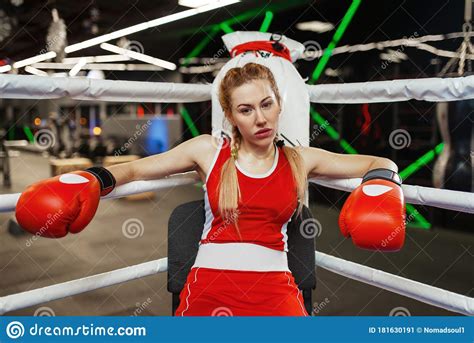 Woman In Gloves Sitting In Corner Of Boxing Ring Stock
