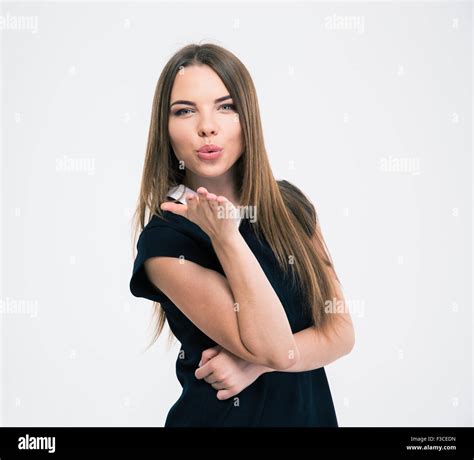 Portrait Of A Young Cute Woman Blowing Kiss At Camera Isolated On A