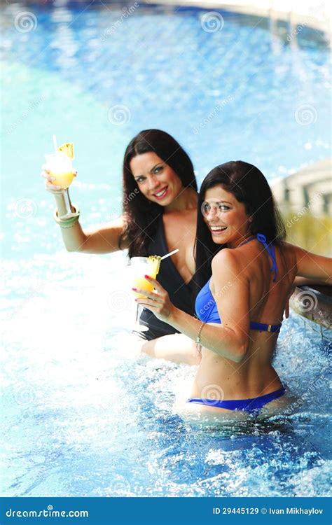 Two Women With Cocktails In Swimming Pool Stock Image Image Of Glass