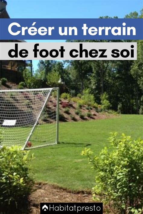 A Soccer Goal Sitting In The Middle Of A Field With Trees And Bushes