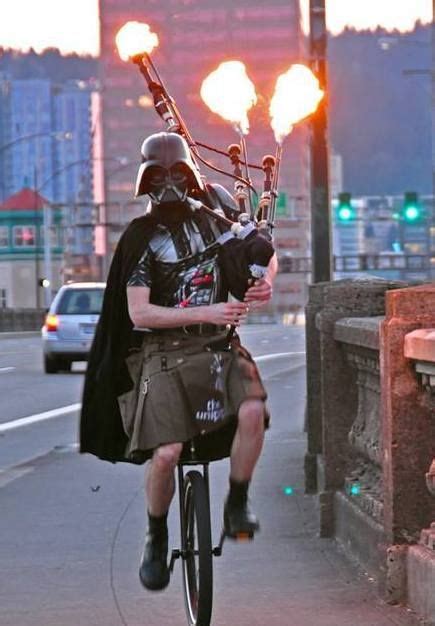 Darth Vader Riding A Unicycle While Playing A Flame Throwing Bagpipe In