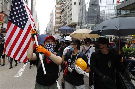 The Latest Hong Kong Protesters Surround Police Station