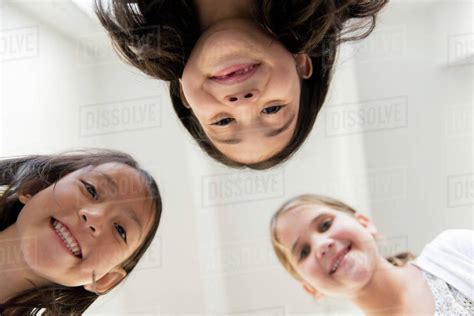 Portrait Of Smiling Girls Looking Down Stock Photo Dissolve
