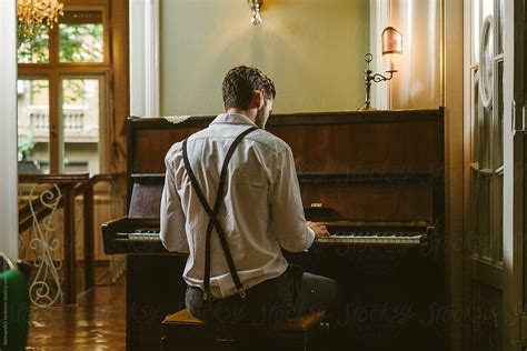 Back View Of A Man Playing Piano By Stocksy Contributor Aleksandra