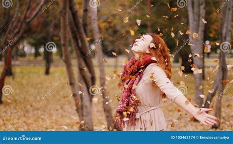 Happy Woman Throwing Leaves In An Autumn Joyful And Excited Young