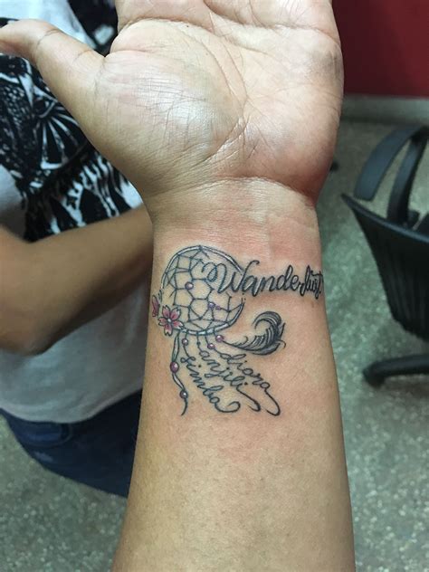 Some girls ink intricate plant stems complete with leaves and flowers, wrapping elegantly around the wrist. Wrist tattoo wanderlust children's names dream catcher ...