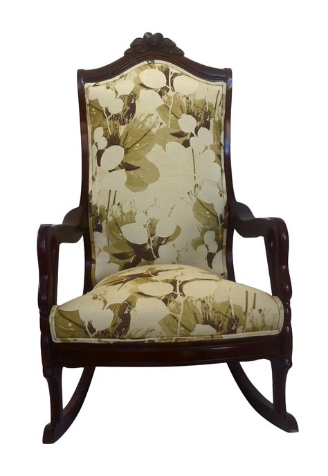 Crafted of solid wood in a warm cherry stain, this chair features a mid backrest, fixed arms, and four carved legs on hooded caster wheels. Carved Wood Rocking Chair | Chairish