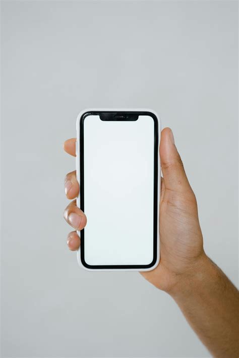 Hand Holding Iphone Mockup · Free Stock Photo