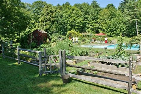 Split rail fences give a rustic, casual look to any property and can provide a level of functionality as well. Split rail fence approaching the vegetable garden | Backyard fences, Fence landscaping, Fence design