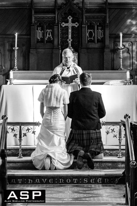 A Bride And Groom Kneel For The Blessing At The High Altar During Their