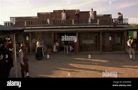 Period Style Reenactment Of Wild West Scene In Front Of Saloon Gun