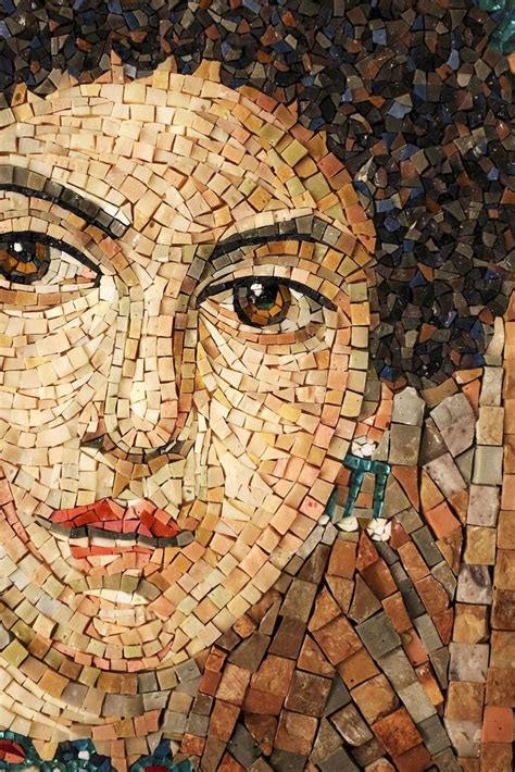 A Close Up Of A Mosaic Face On A Wall