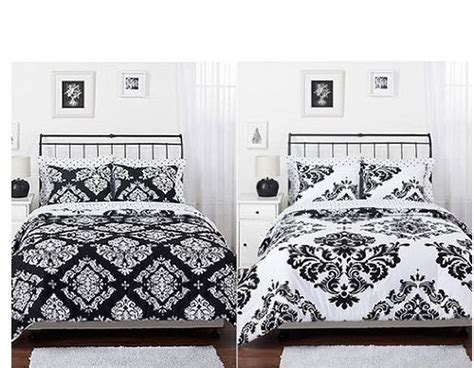 The white flowers on a full black comforter make the comforter set very attractive. Why You Need Black And White Comforters | Trina Turk Bedding