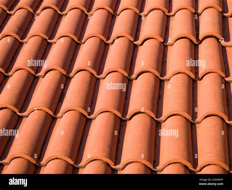 Closeup Of The Red Clay Roof Tiles Shingles Old And Used Overlapping