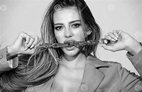sensual woman close up portrait with golden chain in mouth female model lick golden chain face