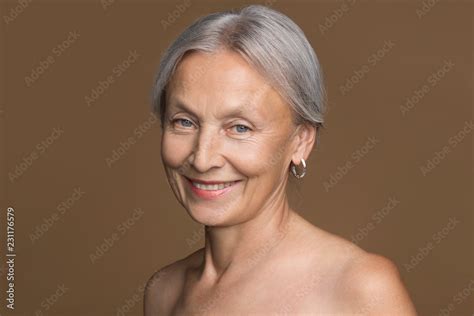 Senior Nude Woman Looking At Camera With A Charming Smile Stock Photo
