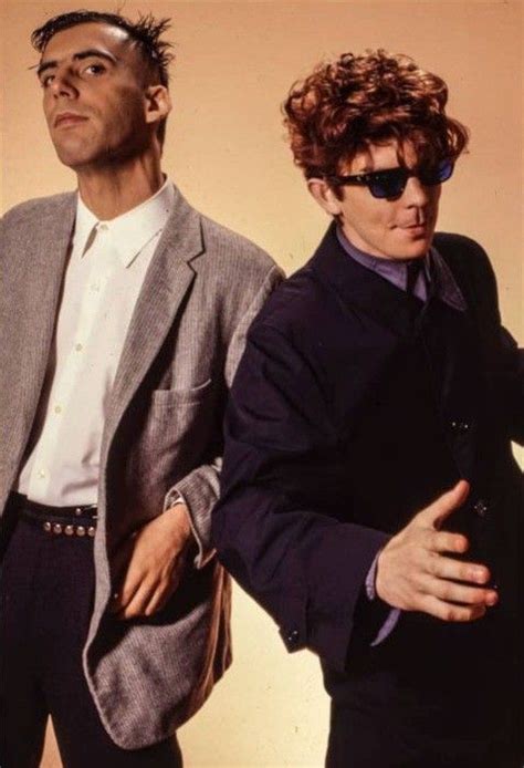 Two Men Standing Next To Each Other Wearing Sunglasses
