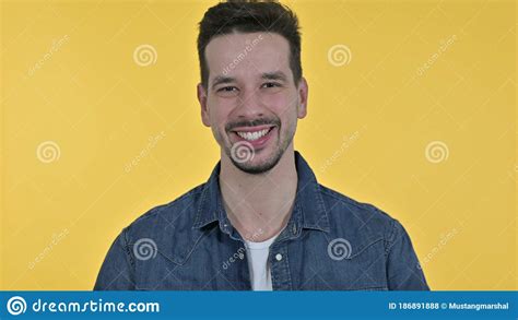 Cheerful Young Man Saying Yes By Shaking Head Yellow Background Stock