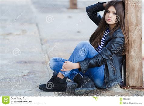 Portrait Of A Young Woman Sitting On The Sidewalk Stock Image Image