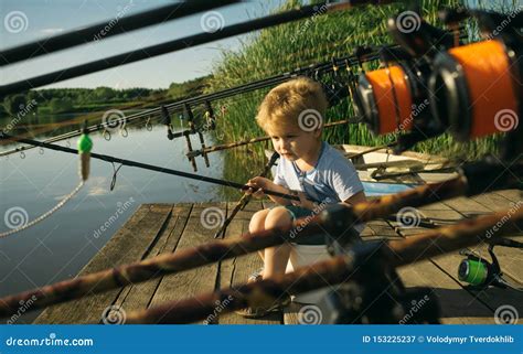 Adorable Little Boy Fishing From Wooden Dock On Lake Stock Image