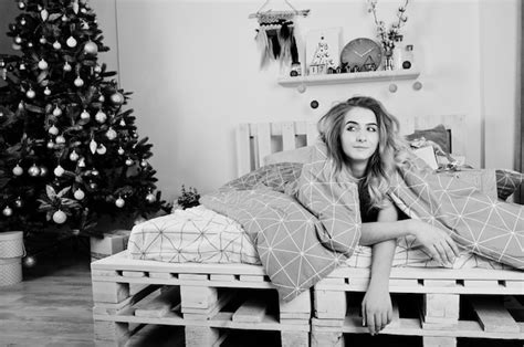 Premium Photo Sexy Naked Blonde Model On Bed With Christmas T Boxes Against New Year Tree