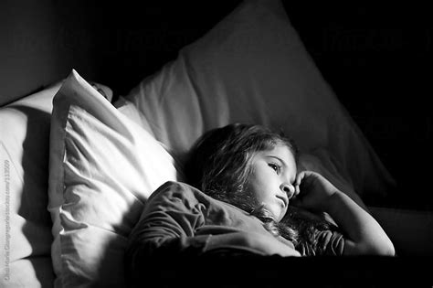 Sad Young Girl Laying In Bed By Dina Giangregorio Stocksy United