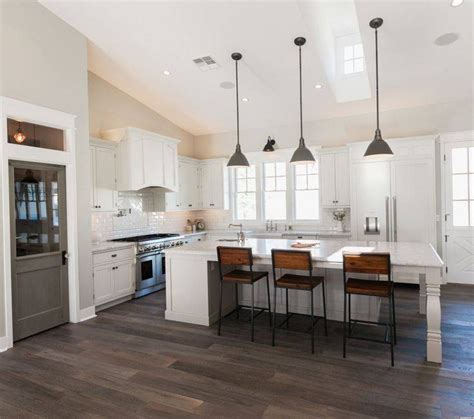 Rustic kitchen showcases a stone brick accent wall and flooring. 15 Ideas of Pendant Lights for Sloped Ceilings