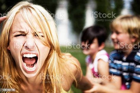 A Mom Going Crazy While Playing With Her Children Stock Photo