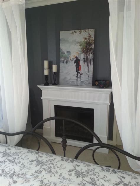 Maybe you would like to learn more about one of these? Grey and white bedroom with romantic fireplace, candles ...
