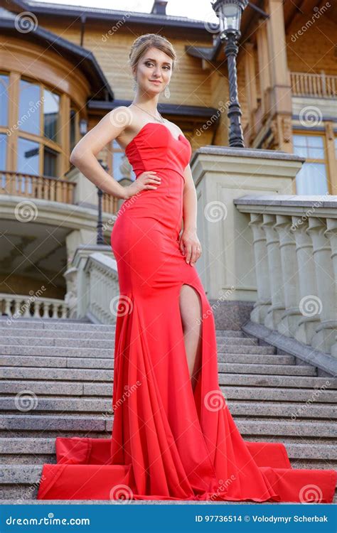 Fashion Outdoor Photo Of Beautiful Woman In Luxurious Red Dress Posing