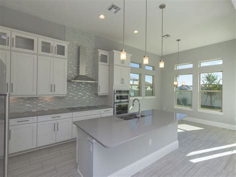 White kitchen cabinets with light grey floors. Love these finishes, especially the counters Transitional ...