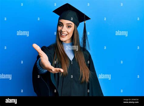 Beautiful Brunette Young Woman Wearing Graduation Cap And Ceremony Robe