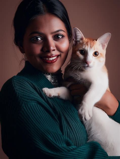 Premium Photo A Woman Holding A Cat In Her Arms