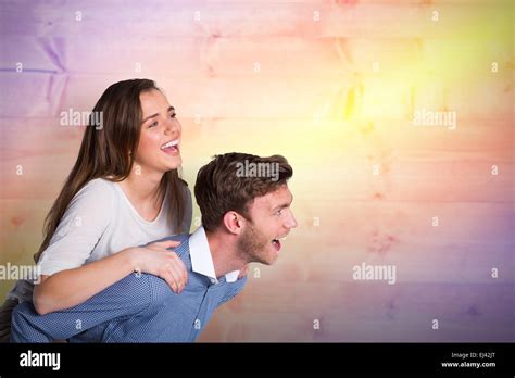 Composite Image Of Smiling Young Man Carrying Woman Stock Photo Alamy