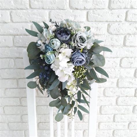 Here's our dusty blue and cream pinterest board that inspired this combination of flowers (you must be logged in to view). Dusty blue cascading bouquet Bridal eucalyptus cascading ...