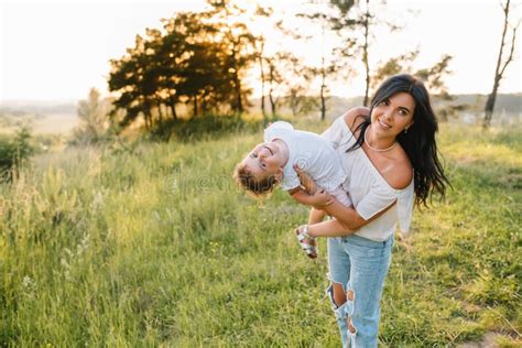 Stylish Mother And Handsome Babe Having Fun On The Nature Happy Family Concept Stock Image