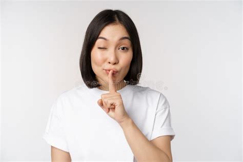 Close Up Portrait Of Young Beautiful Asian Girl Shushing Has Secret Keep Quiet Silence Gesture