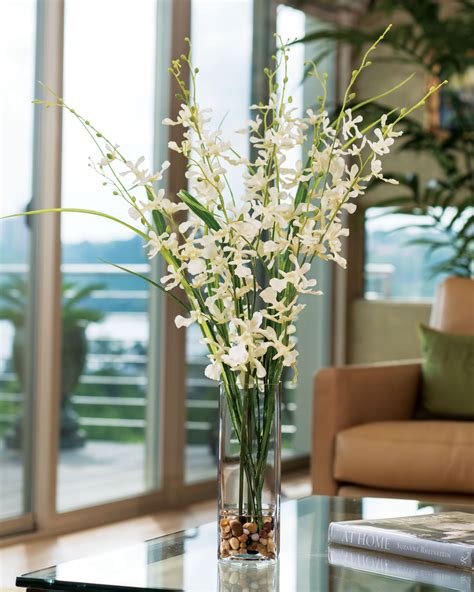 My client had asked me to source a large coffee table for the family room. Artificial Dancing Orchid & Grass Flower Arrangement at Petals