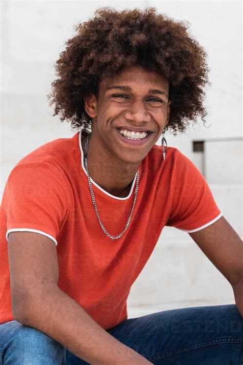 Confident Young African American Man With Curly Hair In Stylish Outfit