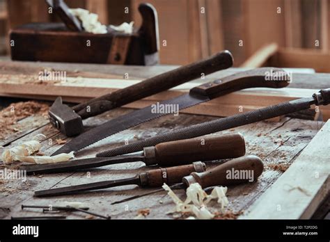 Selection Of Old Vintage Tools On A Woodworking Workbench With Chisels