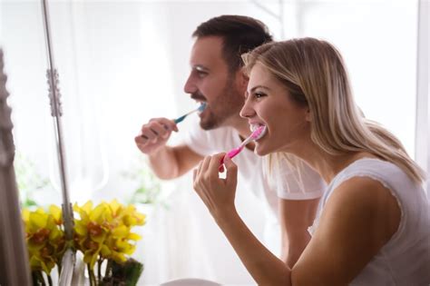 Couple Washing Teeth In Morning Dentisis