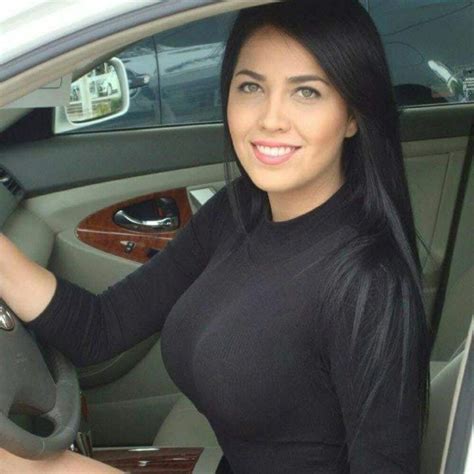 a woman sitting in the driver s seat of a car