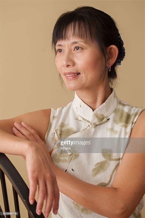 Mature Chinese Woman In Traditional Dress Qipao High-Res Stock Photo ...