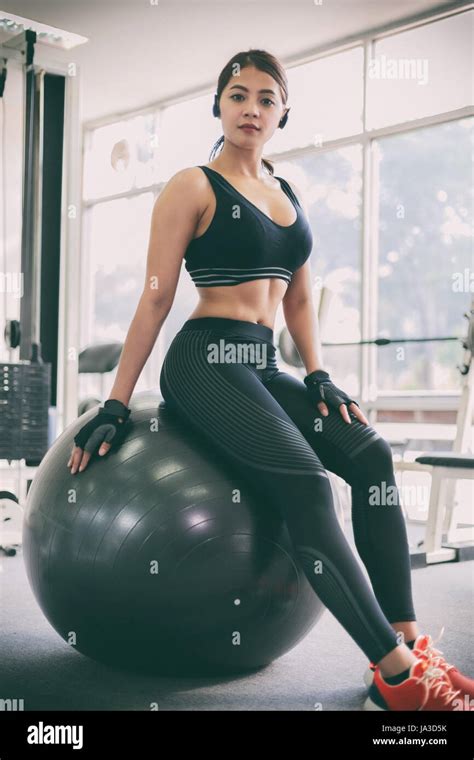 Asian Women Beautiful Sports Girl Does Exercises On A Fitball At Stock