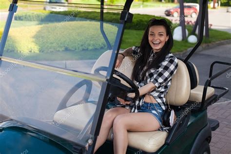 The Woman Is In A Golf Cart Stock Photo By ©dmitroza 119220654
