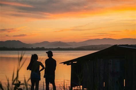 Silhouette Of 2 Person Standing On Wooden Dock During Sunset · Free