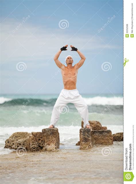 Healthy Man Doing Pilates Yoga Meditation On Beach Summer Stock Photo