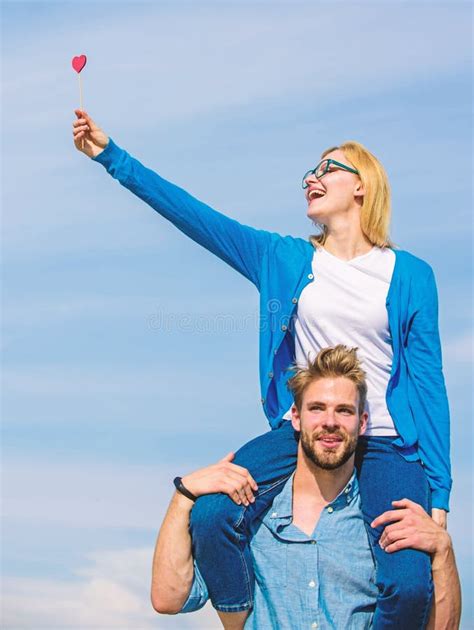 Man Carries Girlfriend On Shoulders Sky Background Couple Happy Date